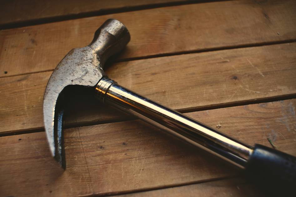 Writer testing claw hammer on lumber