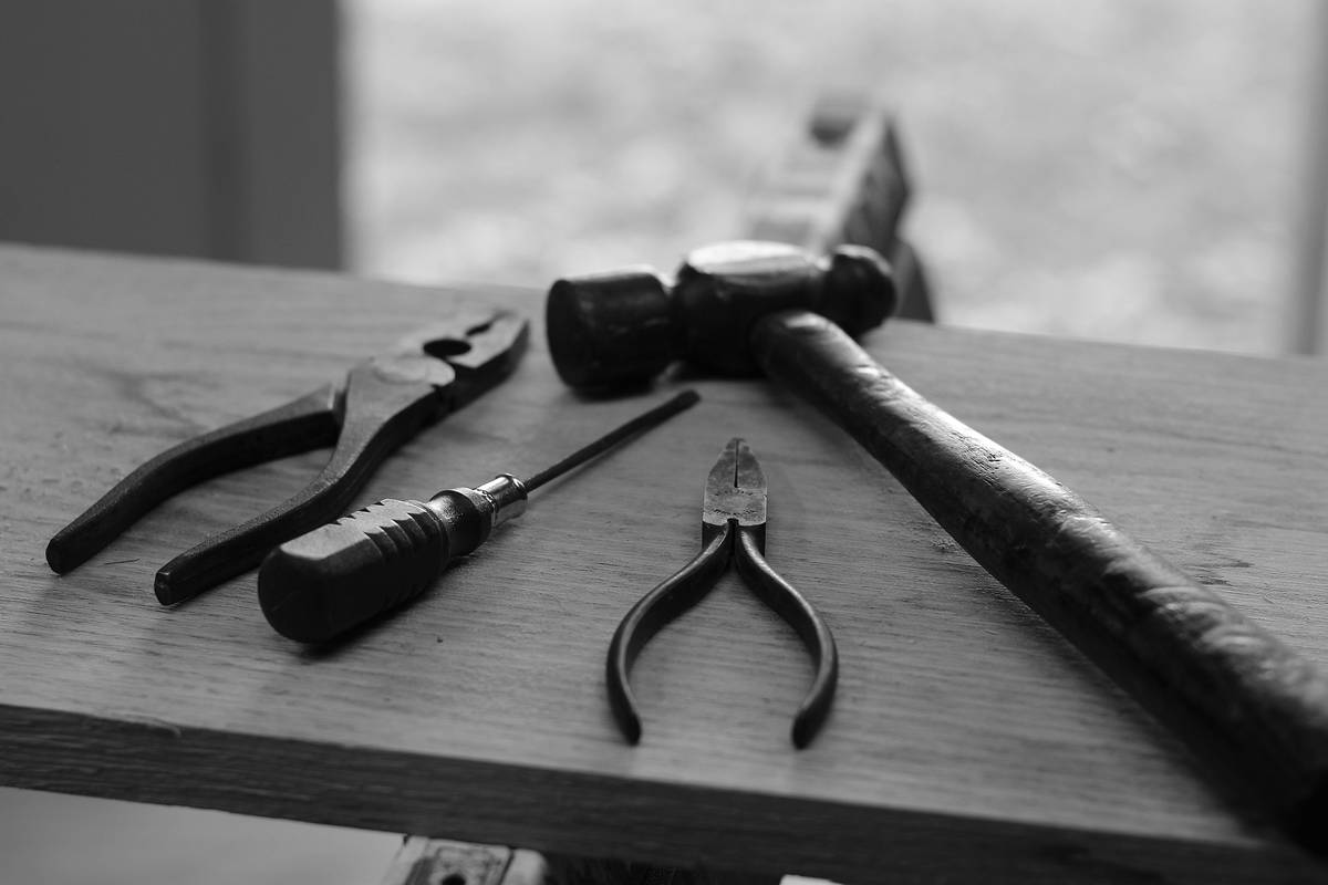 Close-up of multi tool hammer 12 in 1 showing integrated wire cutter and pry bar features